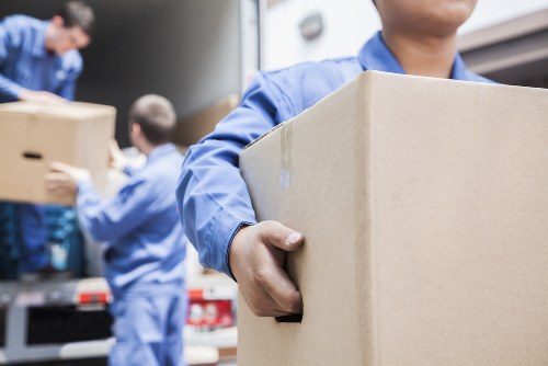 Professional packers securely wrapping household items